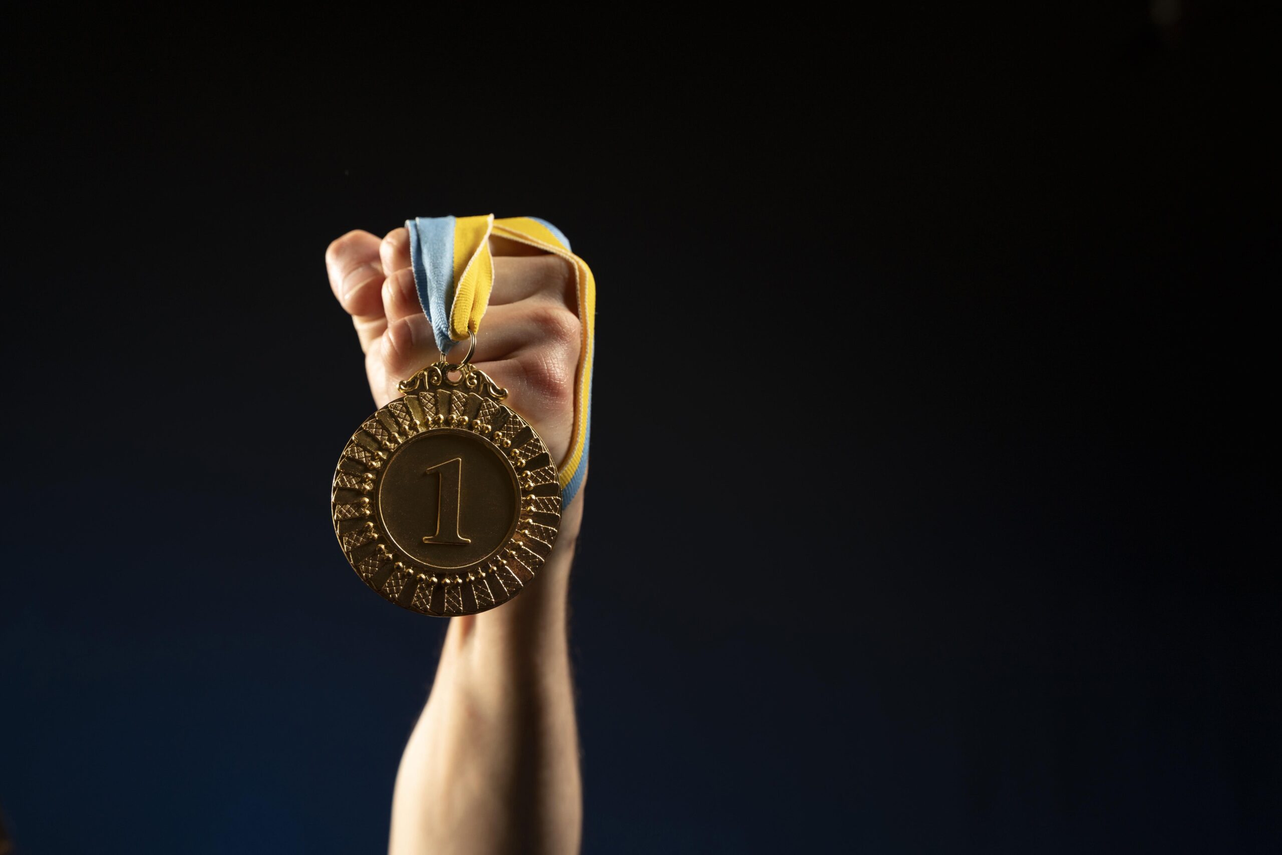 male athlete holding medal